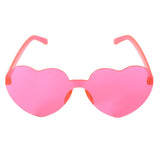 Heart-shaped pink Perspex party glasses. Description: These vibrant party glasses are crafted from pink Perspex material, forming a whimsical heart shape. The transparent pink color adds a playful touch, making them the perfect accessory for festive occasions