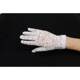 Wrist length short white lace gloves for ladies.